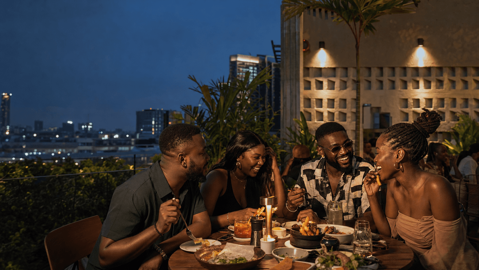 Guests enjoying a rooftop dinner in Lagos during their stay